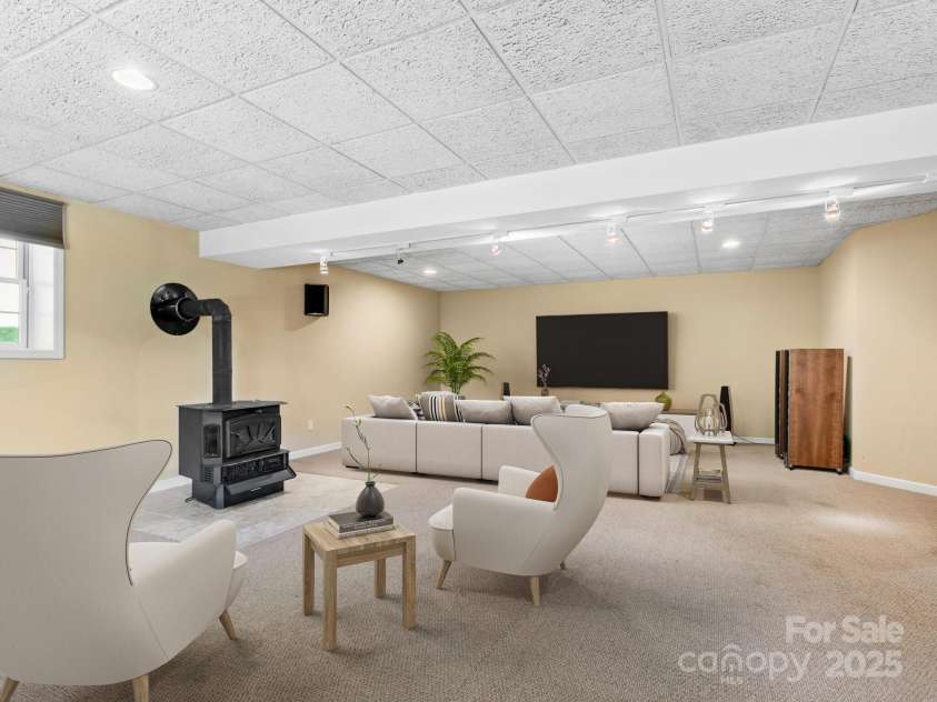 515 Pond Road, Asheville, NC 28806.  MLS# CAR4302486, YatesRealty ID 7674. Massive additional family room downstairs, turn your movie night into a real theater experience! Virtually staged to show furniture placement. 