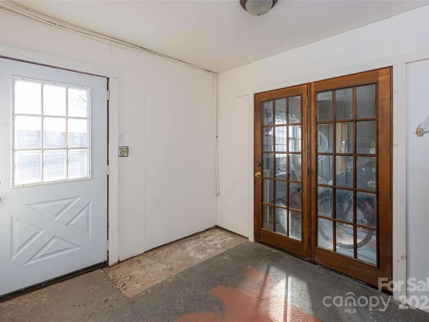 115 Elk Mountain Road, Asheville, NC 28804.  MLS# CAR4219629, YatesRealty ID 7675. Back of bldg entrance hall to workshop, storage, and second bath