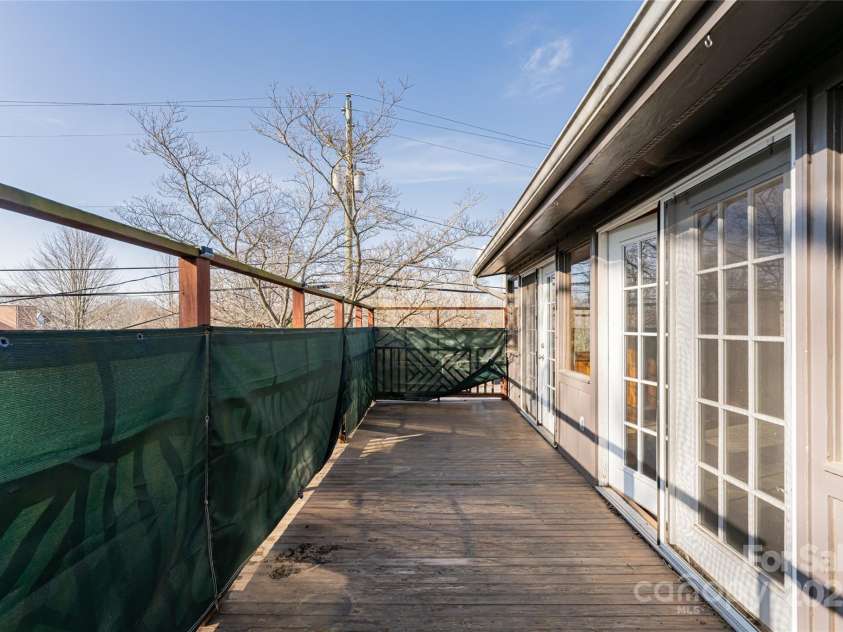 115 Elk Mountain Road, Asheville, NC 28804.  MLS# CAR4219629, YatesRealty ID 7675. Deck off of sunroom