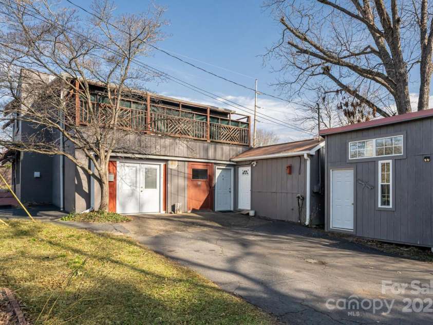 115 Elk Mountain Road, Asheville, NC 28804.  MLS# CAR4219629, YatesRealty ID 7675. Right side street view of property with bonus shed on the right