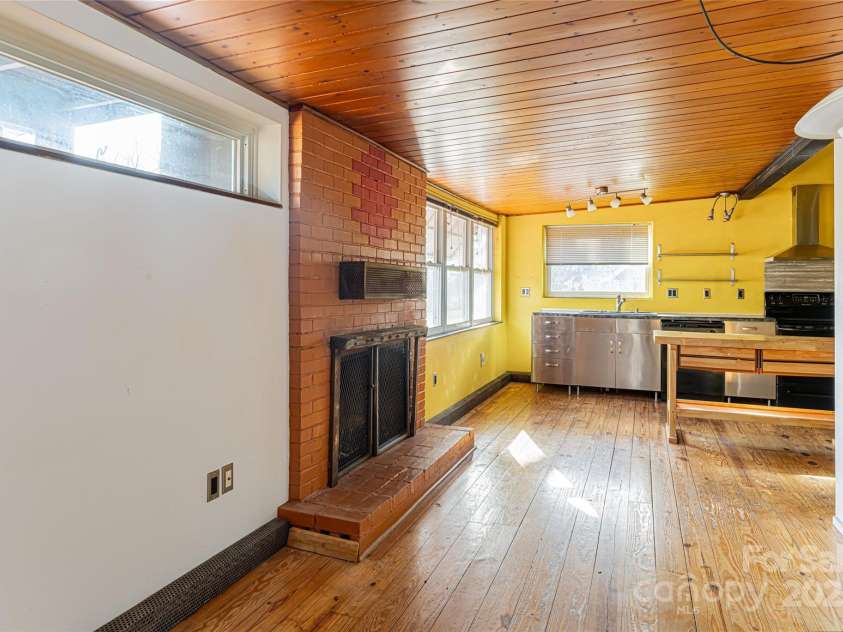 115 Elk Mountain Road, Asheville, NC 28804.  MLS# CAR4219629, YatesRealty ID 7675. Vented gas fireplace in kitchen and nook (leading to back door)