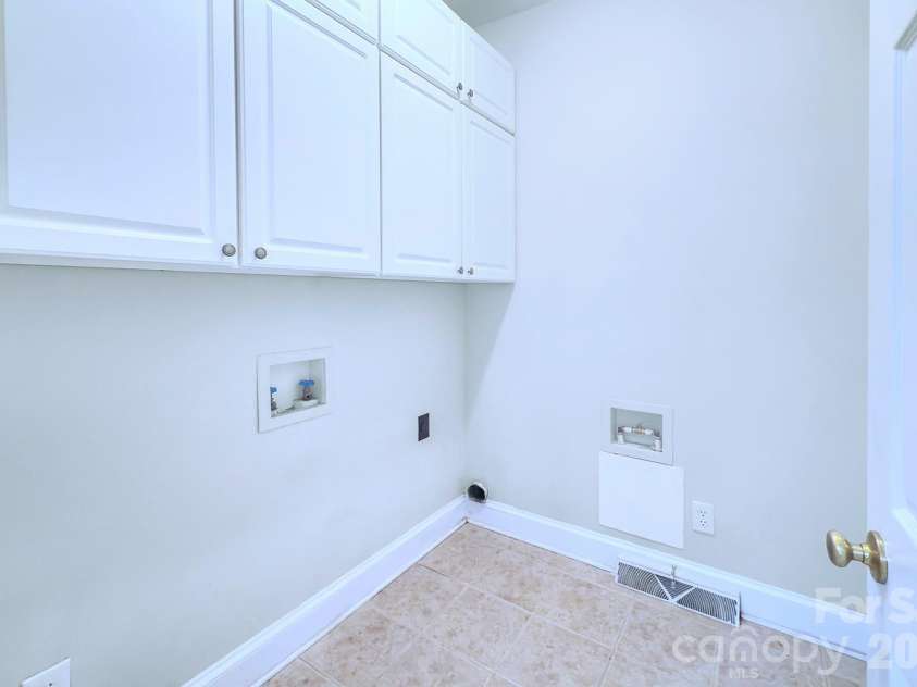 8044 Hawk Crest Court, Charlotte, NC 28270.  MLS# CAR4267919, YatesRealty ID 7700. Laundry room on main level,  cabinets for extra storage and second pantry/overflow from kitchen