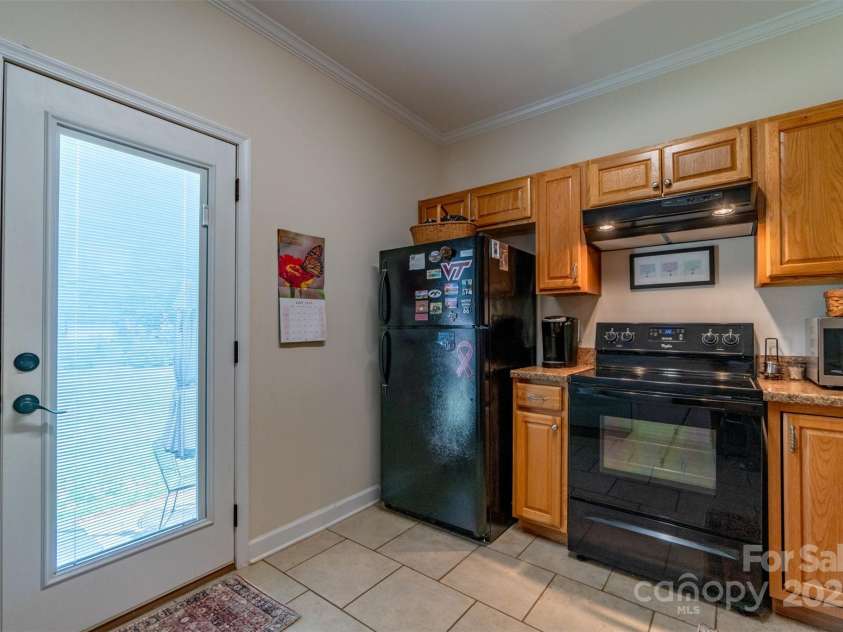 1519 Triplett Road, Cleveland, NC 27013.  MLS# CAR4218302, YatesRealty ID 7715. Bright And Airy Kitchen With Outside Door To Private Hand-Stamped Concrete Patio.