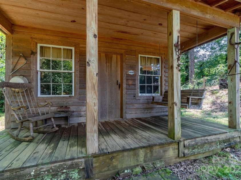 1519 Triplett Road, Cleveland, NC 27013.  MLS# CAR4218302, YatesRealty ID 7715. Creekside cabin in the woods.  Enjoy a good book on the porch swing!
