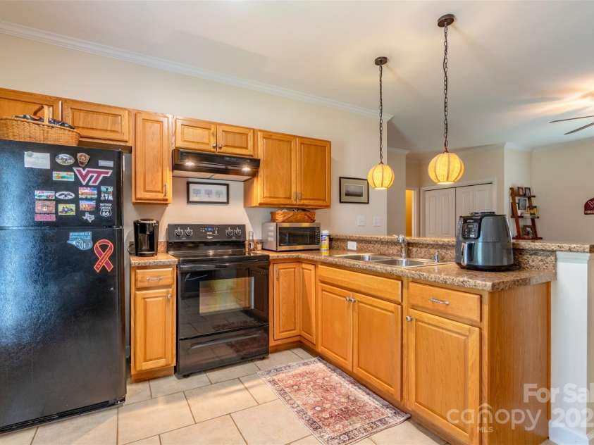 1519 Triplett Road, Cleveland, NC 27013.  MLS# CAR4218302, YatesRealty ID 7715. Kitchen With Oak Wood Cabinets And Granite Countertops Opens To Family Room