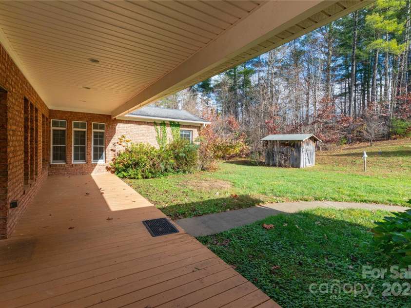 1025 Upper Brush Creek Road, Fairview, NC 28730.  MLS# CAR4195772, YatesRealty ID 7723. Covered back deck.