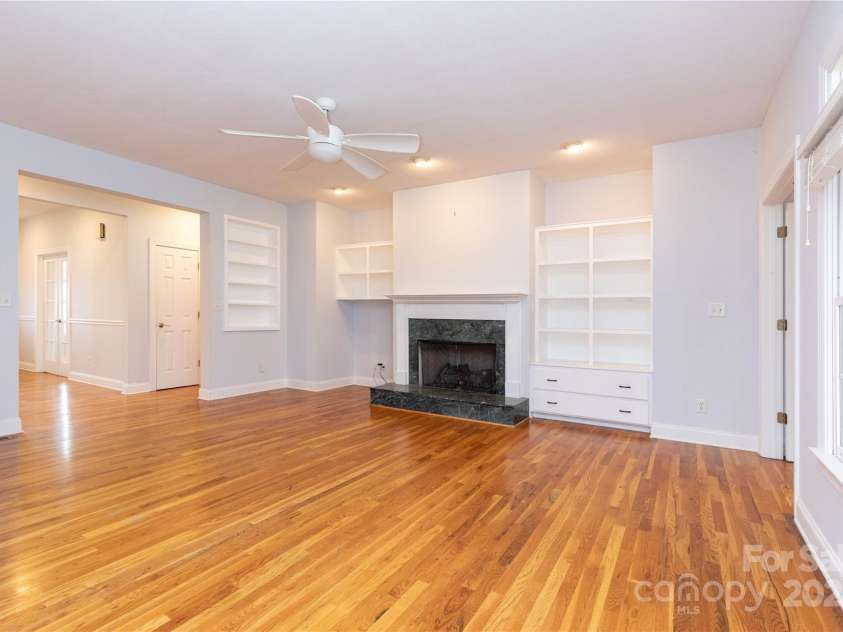 1025 Upper Brush Creek Road, Fairview, NC 28730.  MLS# CAR4195772, YatesRealty ID 7723. Large living space with built ins and fireplace.