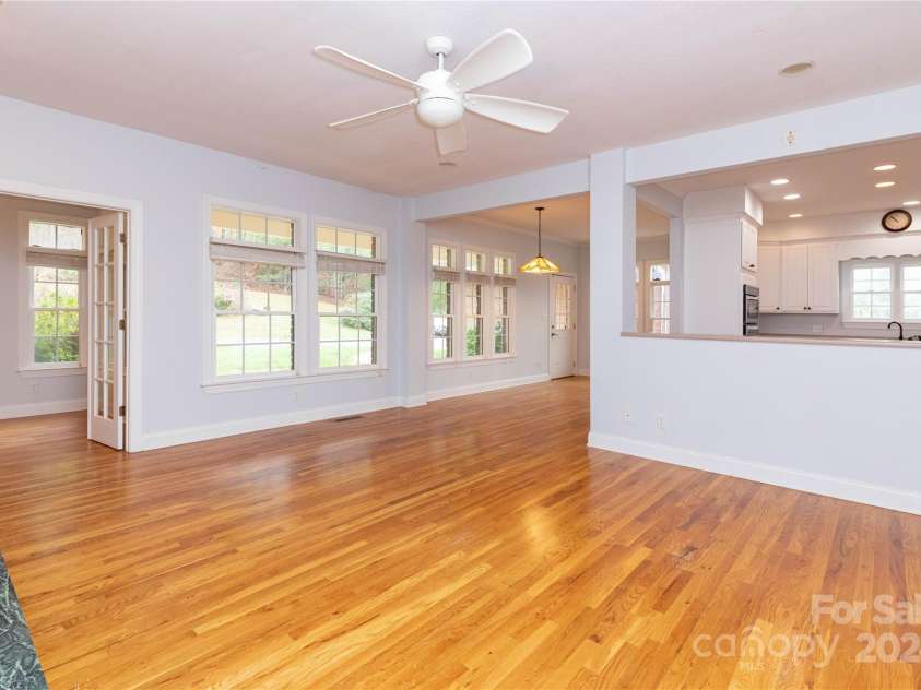 1025 Upper Brush Creek Road, Fairview, NC 28730.  MLS# CAR4195772, YatesRealty ID 7723. Living space open to kitchen in dining room.