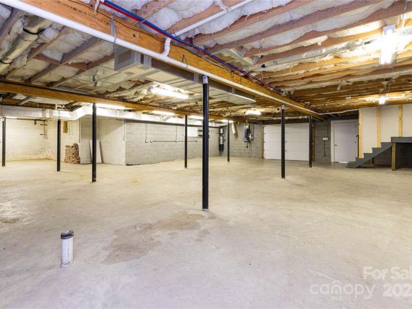 1025 Upper Brush Creek Road, Fairview, NC 28730.  MLS# CAR4195772, YatesRealty ID 7723. Massive unfinished basement.