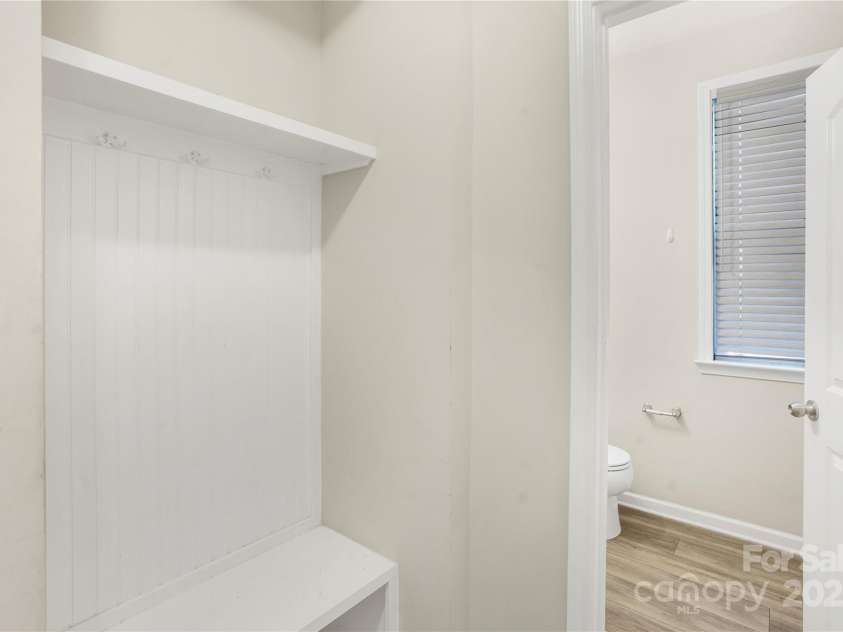 7535 Meridale Forest Drive, Charlotte, NC 28269.  MLS# CAR4221916, YatesRealty ID 7726. Mud room and half bathroom to the left of front door