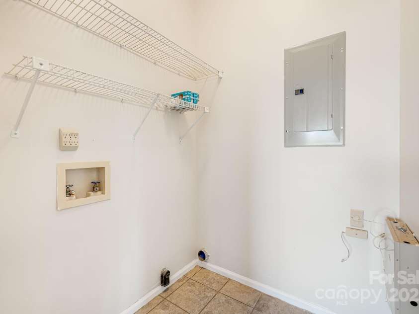 546 Windswept Drive, Asheville, NC 28801.  MLS# CAR4248242, YatesRealty ID 7747. Laundry Room with Storage Shelves