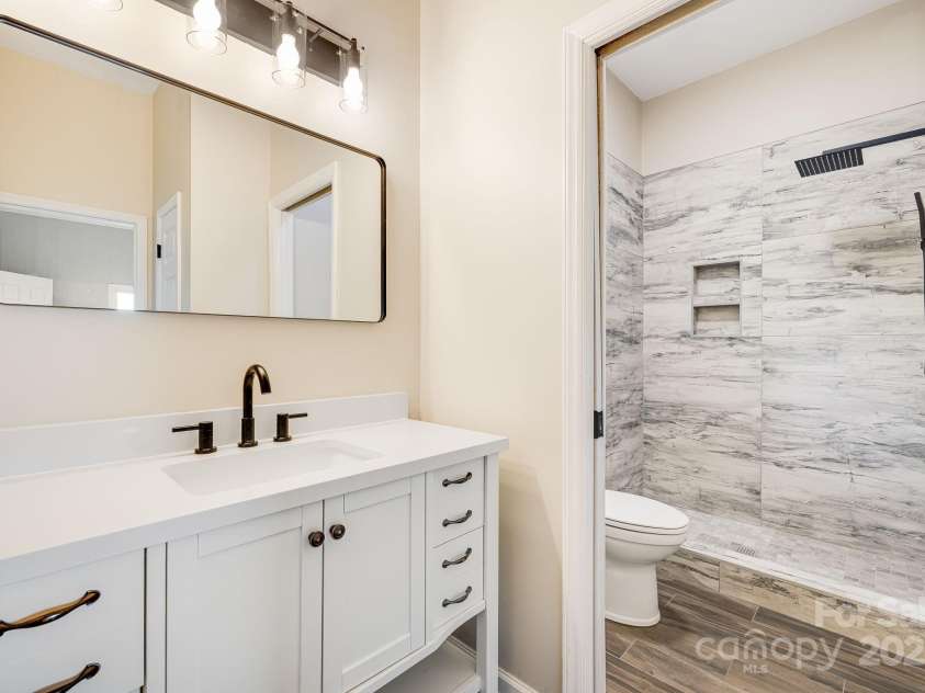 546 Windswept Drive, Asheville, NC 28801.  MLS# CAR4248242, YatesRealty ID 7747. Quartz-Topped Vanity and Luxurious Shower