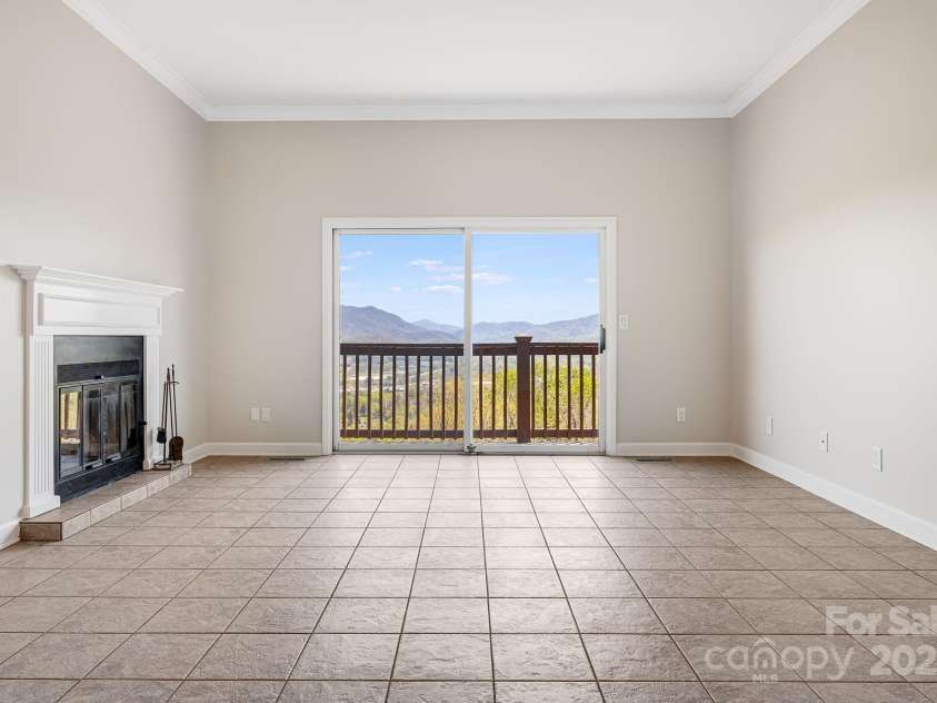 546 Windswept Drive, Asheville, NC 28801.  MLS# CAR4248242, YatesRealty ID 7747. Spacious Living Room with Deck Access and Layered Mountain Views