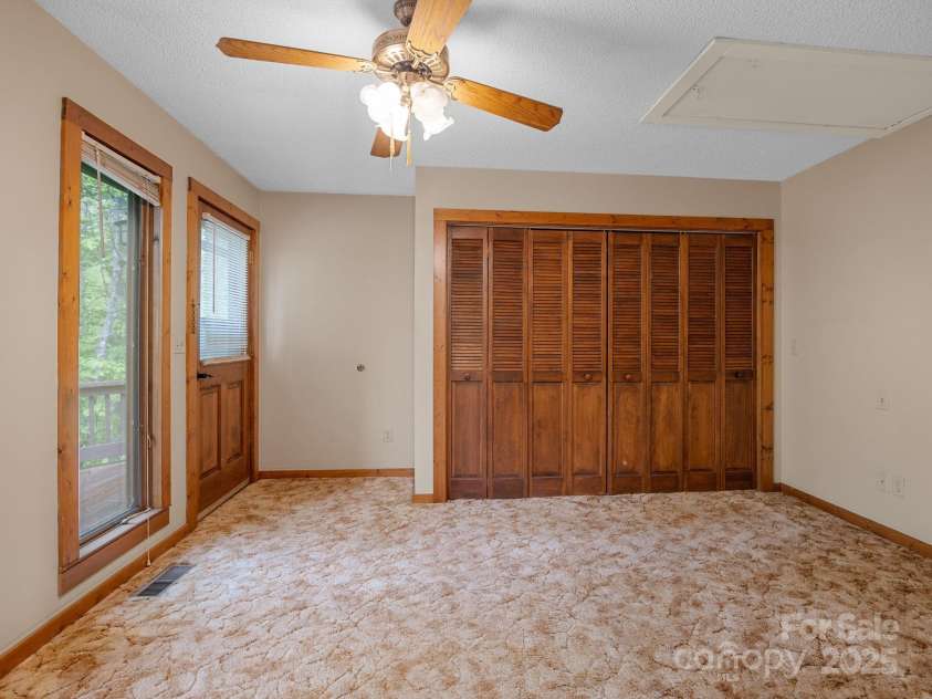 241 Pinefield Drive, Tryon, NC 28782.  MLS# CAR4250675, YatesRealty ID 7781. Bedroom with exterior door.