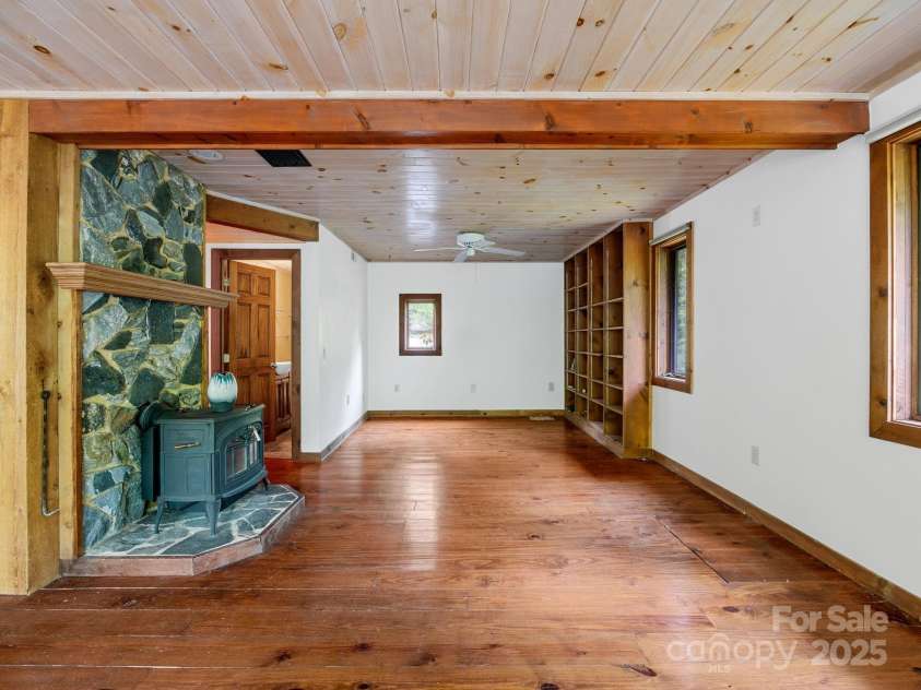 241 Pinefield Drive, Tryon, NC 28782.  MLS# CAR4250675, YatesRealty ID 7781. Family room looking into the living room