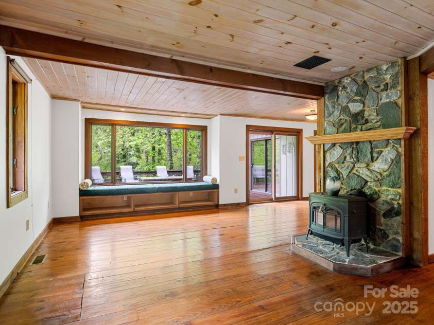 241 Pinefield Drive, Tryon, NC 28782.  MLS# CAR4250675, YatesRealty ID 7781. Family Room with wood stove.