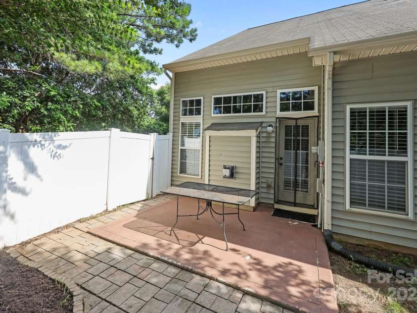 157 Talbert Town Loop, Mooresville, NC 28117.  MLS# CAR4275310, YatesRealty ID 7789. Step outside to a fenced backyard that offers a great balance of comfort and privacy. Enjoy a nice patio area, perfect for relaxing, grilling, or entertaining guests. A couple of mature trees provide shade and a nat