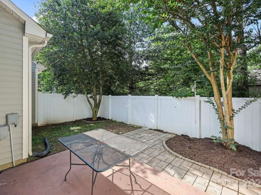 157 Talbert Town Loop, Mooresville, NC 28117.  MLS# CAR4275310, YatesRealty ID 7789. Step outside to a fenced backyard that offers a great balance of comfort and privacy. Enjoy a nice patio area, perfect for relaxing, grilling, or entertaining guests. A couple of mature trees provide shade and a nat