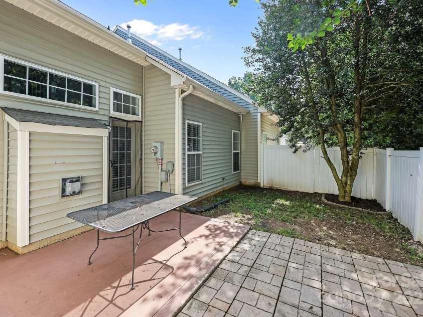 157 Talbert Town Loop, Mooresville, NC 28117.  MLS# CAR4275310, YatesRealty ID 7789. Step outside to a fenced backyard that offers a great balance of comfort and privacy. Enjoy a nice patio area, perfect for relaxing, grilling, or entertaining guests. A couple of mature trees provide shade and a nat