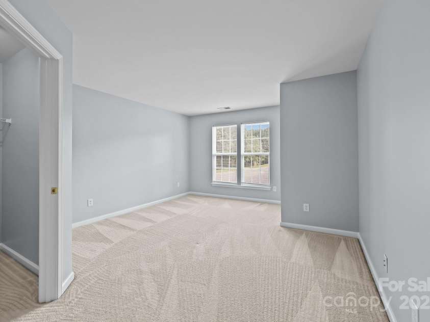 157 Talbert Town Loop, Mooresville, NC 28117.  MLS# CAR4275310, YatesRealty ID 7789. The two upstairs bedrooms are both generously sized, offering plenty of space for beds, desks, or additional furniture. Each room features its own walk-in closet, providing excellent storage and organization.