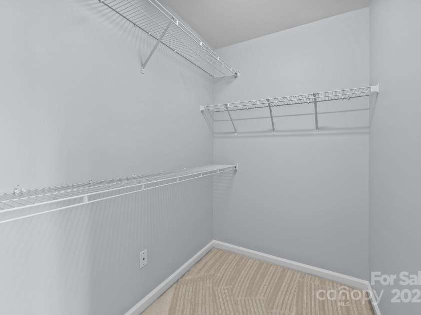 157 Talbert Town Loop, Mooresville, NC 28117.  MLS# CAR4275310, YatesRealty ID 7789. The two upstairs bedrooms are both generously sized, offering plenty of space for beds, desks, or additional furniture. Each room features its own walk-in closet, providing excellent storage and organization.