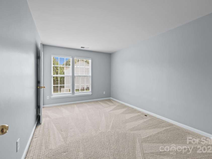 157 Talbert Town Loop, Mooresville, NC 28117.  MLS# CAR4275310, YatesRealty ID 7789. The two upstairs bedrooms are both generously sized, offering plenty of space for beds, desks, or additional furniture. Each room features its own walk-in closet, providing excellent storage and organization.