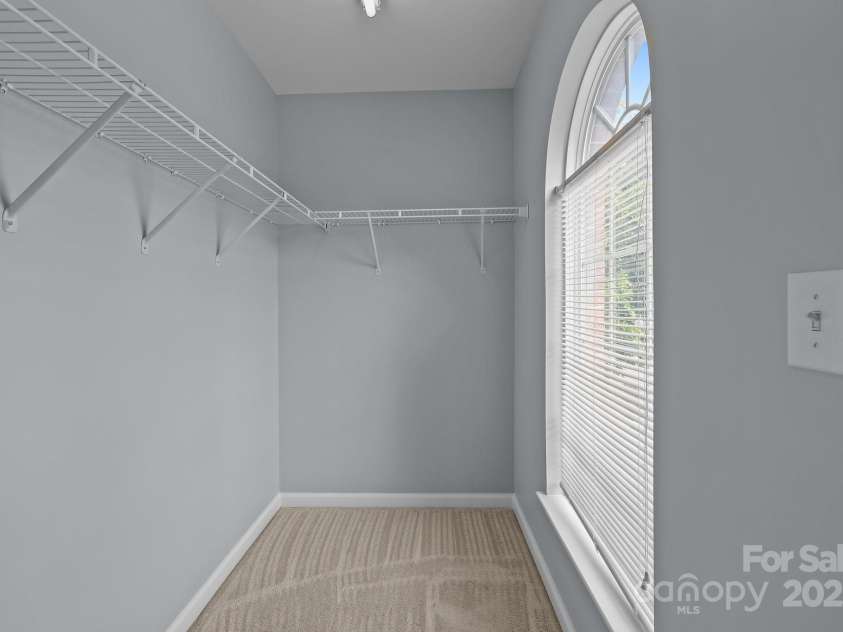 157 Talbert Town Loop, Mooresville, NC 28117.  MLS# CAR4275310, YatesRealty ID 7789. The two upstairs bedrooms are both generously sized, offering plenty of space for beds, desks, or additional furniture. Each room features its own walk-in closet, providing excellent storage and organization.