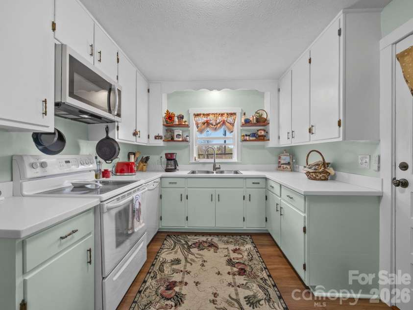 1434 Lake Adger Road, Mill Spring, NC 28756.  MLS# CAR4363547, YatesRealty ID 7791. Kitchen with original cabinetry