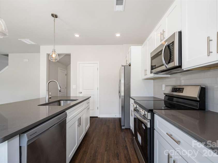 3001 Sadler Woods Lane, Charlotte, NC 28214.  MLS# CAR4272760, YatesRealty ID 781. Quartz Countertops. Stainless steel appliances. Representational Photo.