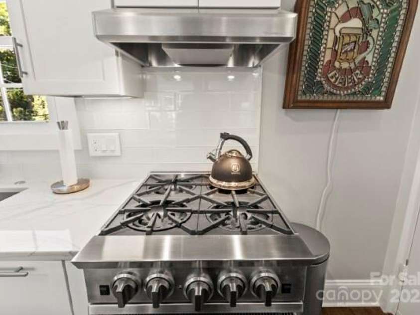 241 Wakefield Drive, Charlotte, NC 28209.  MLS# CAR4248262, YatesRealty ID 7816. 4 Burner Commercial grade gas stove used by some of the Finest of Chefs. Vented to the outside. Has never been used