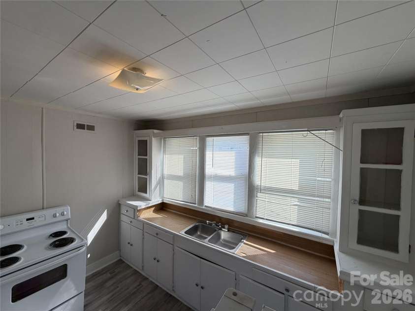 208 3rd Street, Albemarle, NC 28001.  MLS# CAR4358248, YatesRealty ID 7833. Bright, functional kitchen. Oversized windows provide passive lighting, keeping units cheery while lowering tenant electric costs.