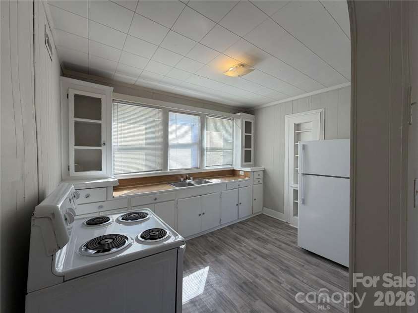 208 3rd Street, Albemarle, NC 28001.  MLS# CAR4358248, YatesRealty ID 7833. Dual-basin sink positioned under a view-window. Natural task lighting makes the kitchen feel bright and inviting, reducing turnover friction.