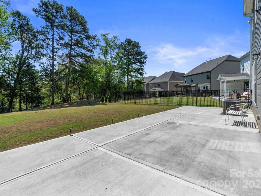 184 Tetcott Street, Mooresville, NC 28115.  MLS# CAR4246979, YatesRealty ID 7848. Oversized patio w/ gas grill hookup. Level Yard, Overlooking trees