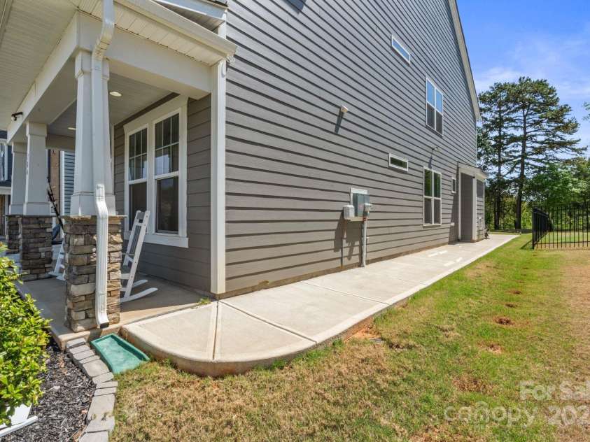184 Tetcott Street, Mooresville, NC 28115.  MLS# CAR4246979, YatesRealty ID 7848. Sidewalk connecting the front porch to the back patio