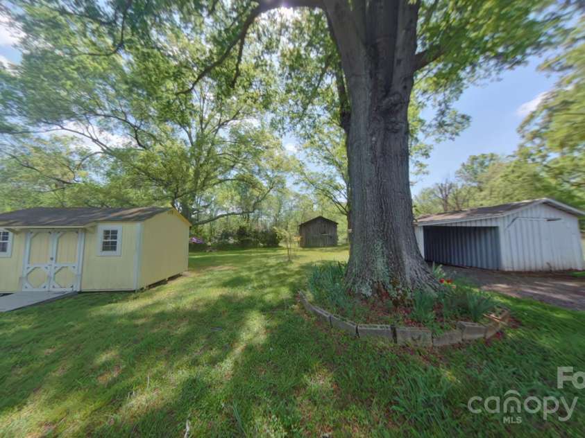 224 McClain Street, York, SC 29745.  MLS# CAR4242431, YatesRealty ID 7865. Rear yard with storage and utility buildings
