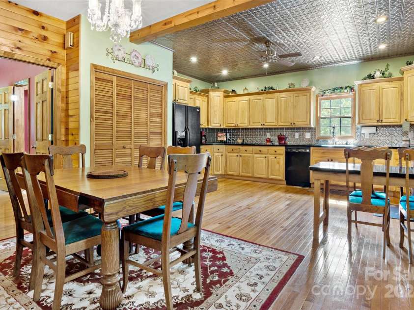 967 Clear Water Drive, Nebo, NC 28761.  MLS# CAR4147969, YatesRealty ID 7868. A wider view of the kitchen. The slatted doors, left center, is the laundry closet, and the door on the left is to the primary bedroom and en suite.