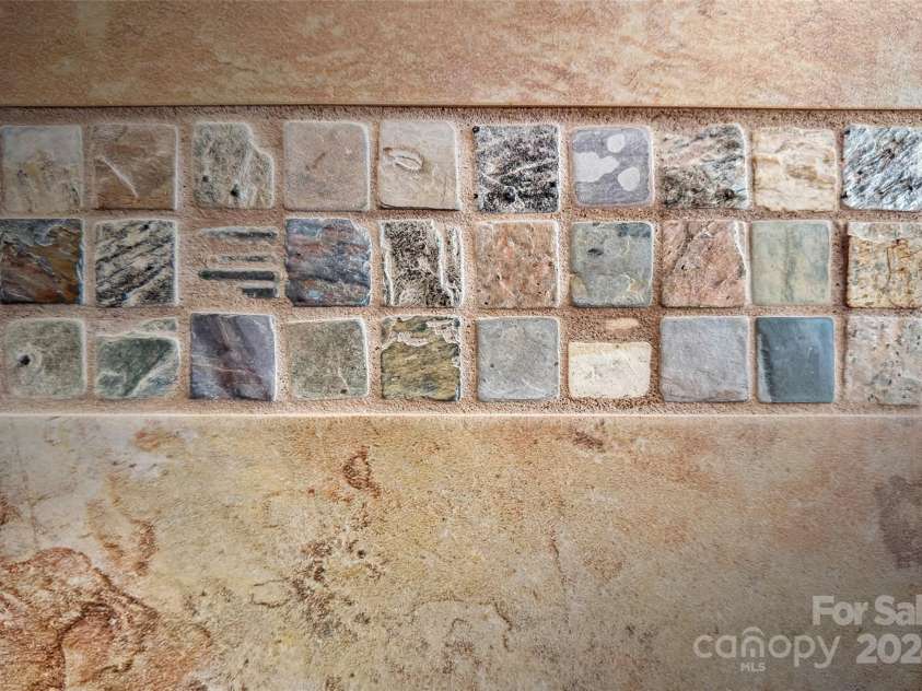 967 Clear Water Drive, Nebo, NC 28761.  MLS# CAR4147969, YatesRealty ID 7868. Details of a fine tile job in the Primary bath.