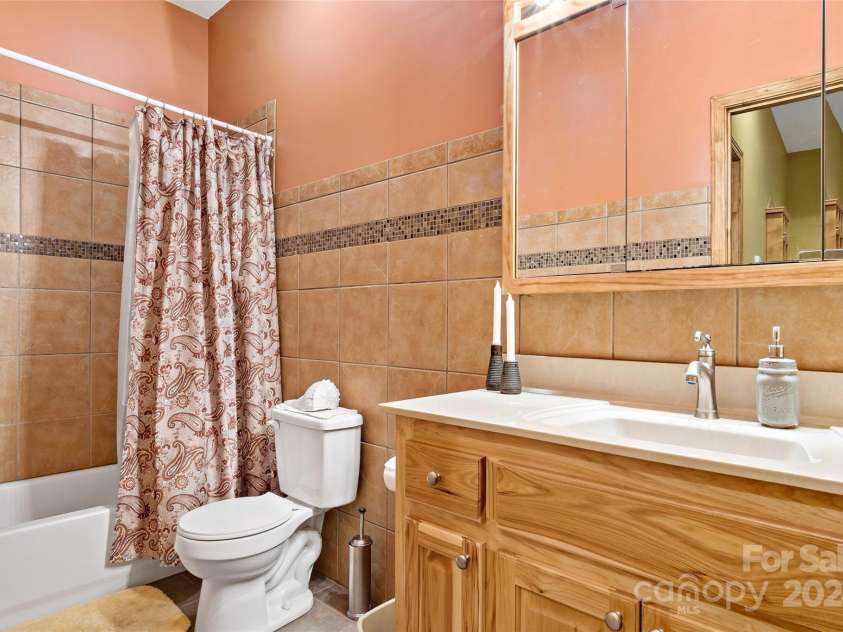 967 Clear Water Drive, Nebo, NC 28761.  MLS# CAR4147969, YatesRealty ID 7868. Downstairs bath adjacent to the Bedroom there - such utility