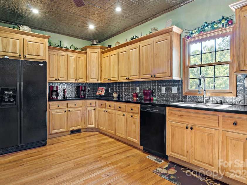 967 Clear Water Drive, Nebo, NC 28761.  MLS# CAR4147969, YatesRealty ID 7868. Oak floors, real metal ceilings and backsplash - not to mention that gorgeous black granite countertop - add a flair to parties in the kitchen