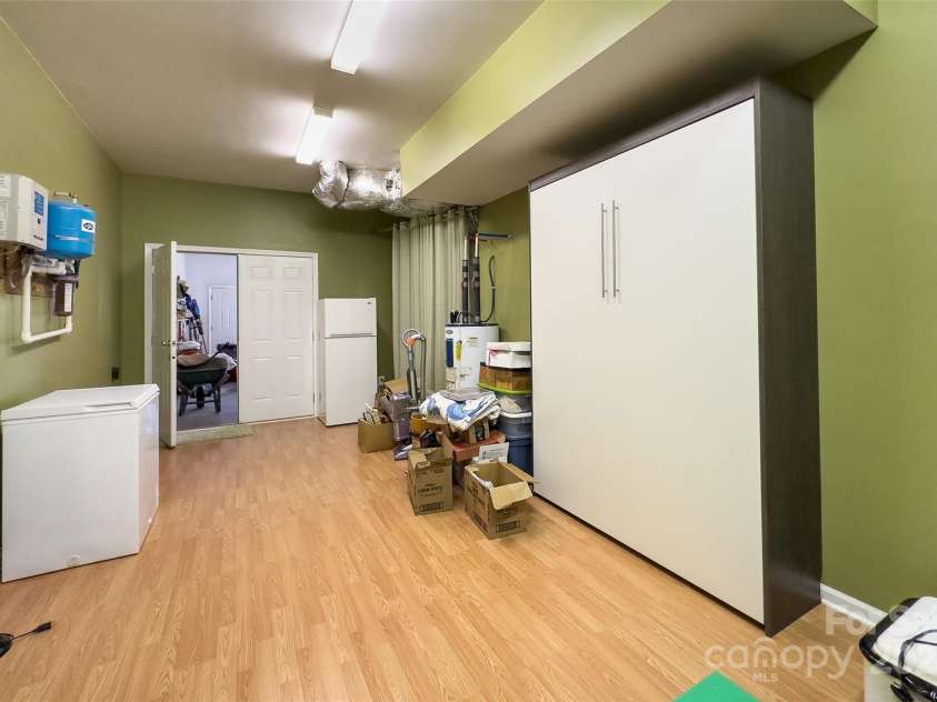 967 Clear Water Drive, Nebo, NC 28761.  MLS# CAR4147969, YatesRealty ID 7868. Speaking of good space, this basement level room, behind the garage, is conditioned (heat and air), used as a work-out room and even has a Murphy bed for overflow guests. Make it what you will!