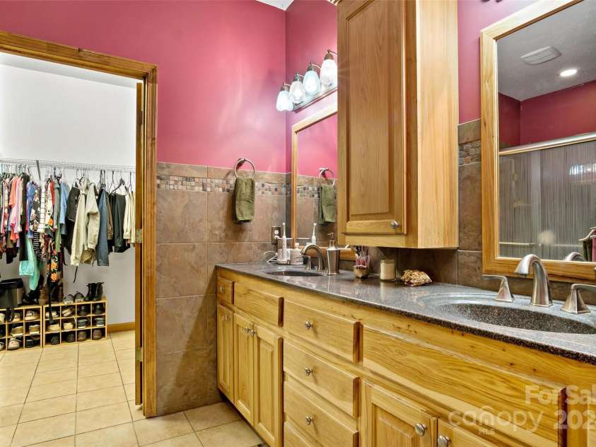 967 Clear Water Drive, Nebo, NC 28761.  MLS# CAR4147969, YatesRealty ID 7868. This is a beautiful bathroom. Double sinks, a private toilet and a large shower with seat. Good storage here, too. That's the spacious Walk In Closet just ahead.