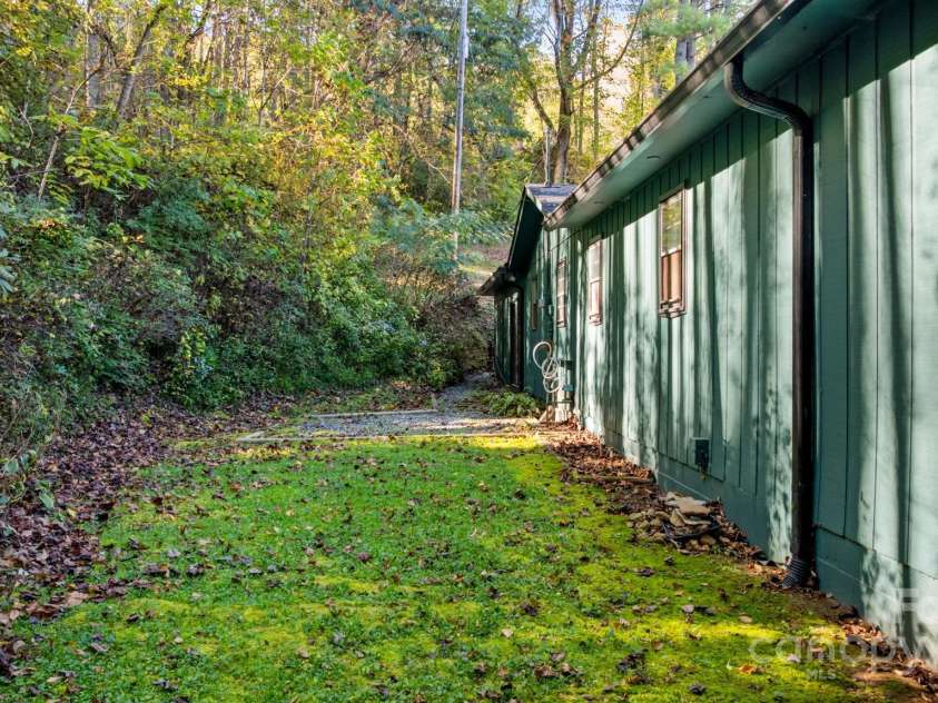 621 Kitchens Branch Road, Sylva, NC 28779.  MLS# CAR4318582, YatesRealty ID 7887. Backyard from sliders in bay one