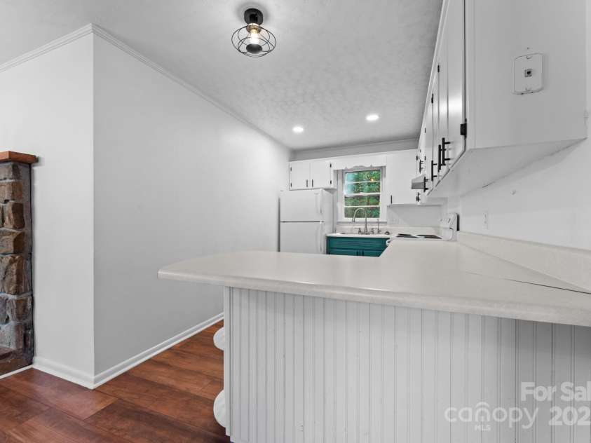 621 Kitchens Branch Road, Sylva, NC 28779.  MLS# CAR4318582, YatesRealty ID 7887. Kitchen from peninsula and dining room