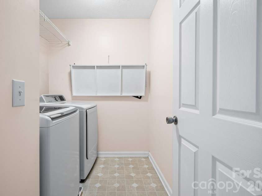 2737 Mill Valley Court, Matthews, NC 28105.  MLS# CAR4394021, YatesRealty ID 7894. Spacious walk in laundry room located upstairs with custom drop down folding table and additional storage