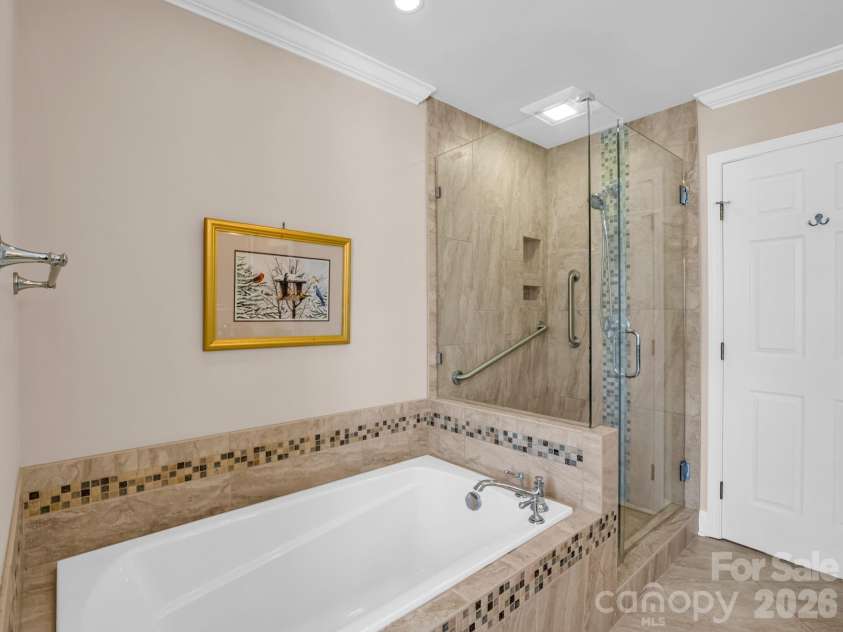 111 Broadmoor Drive, Flat Rock, NC 28731.  MLS# CAR4358626, YatesRealty ID 7915. Soaking tub & shower with frameless door 