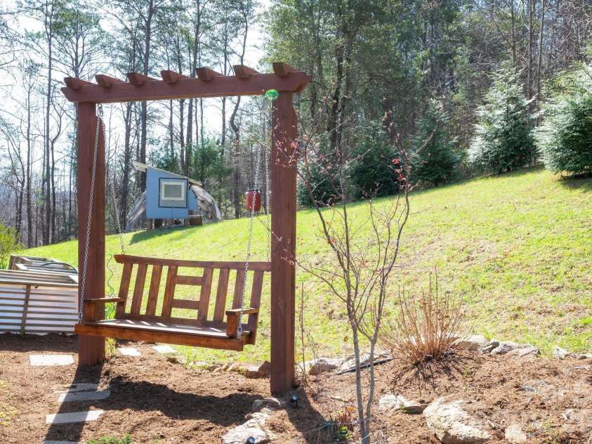 132 Peaceful View Drive, Fairview, NC 28730.  MLS# CAR4363151, YatesRealty ID 7917. Garden swing seating area