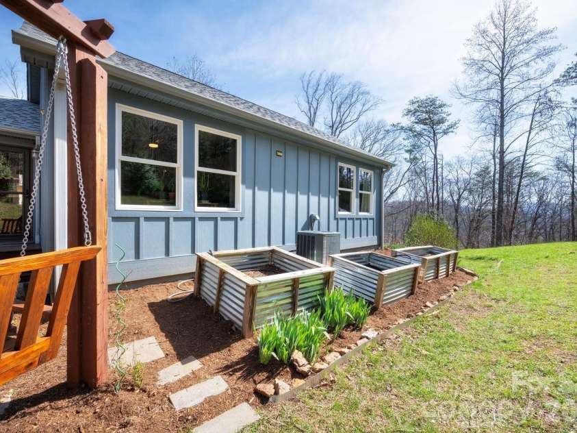 132 Peaceful View Drive, Fairview, NC 28730.  MLS# CAR4363151, YatesRealty ID 7917. Raised garden beds exterior