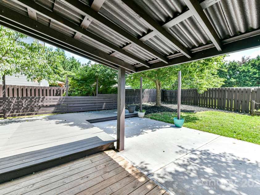 112 Denham Place, Mooresville, NC 28115.  MLS# CAR4237866, YatesRealty ID 7931. Covered Patio with plenty of deck area for seating & Fenced Back Yard!