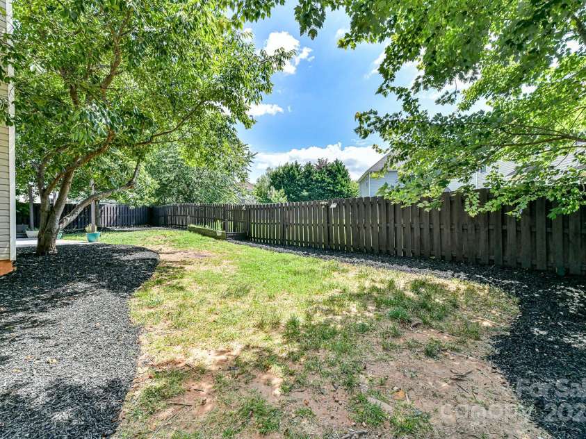 112 Denham Place, Mooresville, NC 28115.  MLS# CAR4237866, YatesRealty ID 7931. Fenced Back Yard with mature trees for shade/privacy!