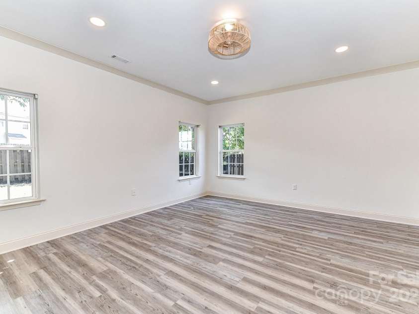 112 Denham Place, Mooresville, NC 28115.  MLS# CAR4237866, YatesRealty ID 7931. Great Room offers custom light fixture & LVP floors!